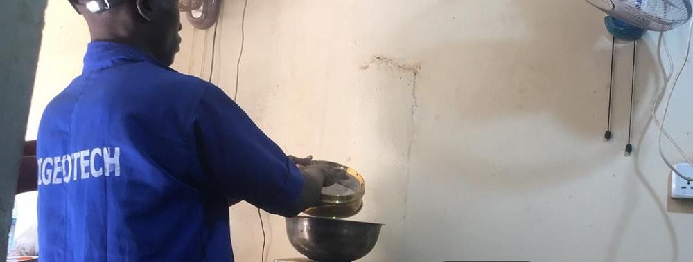 Cigeotech technician performing sieve analysis in the materials laboratory